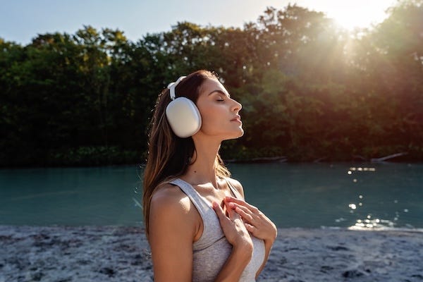 Young woman with headphones enjoying healing music