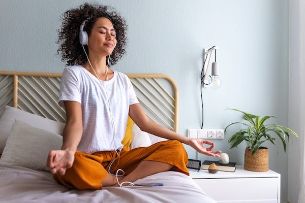 Young woman meditating at home